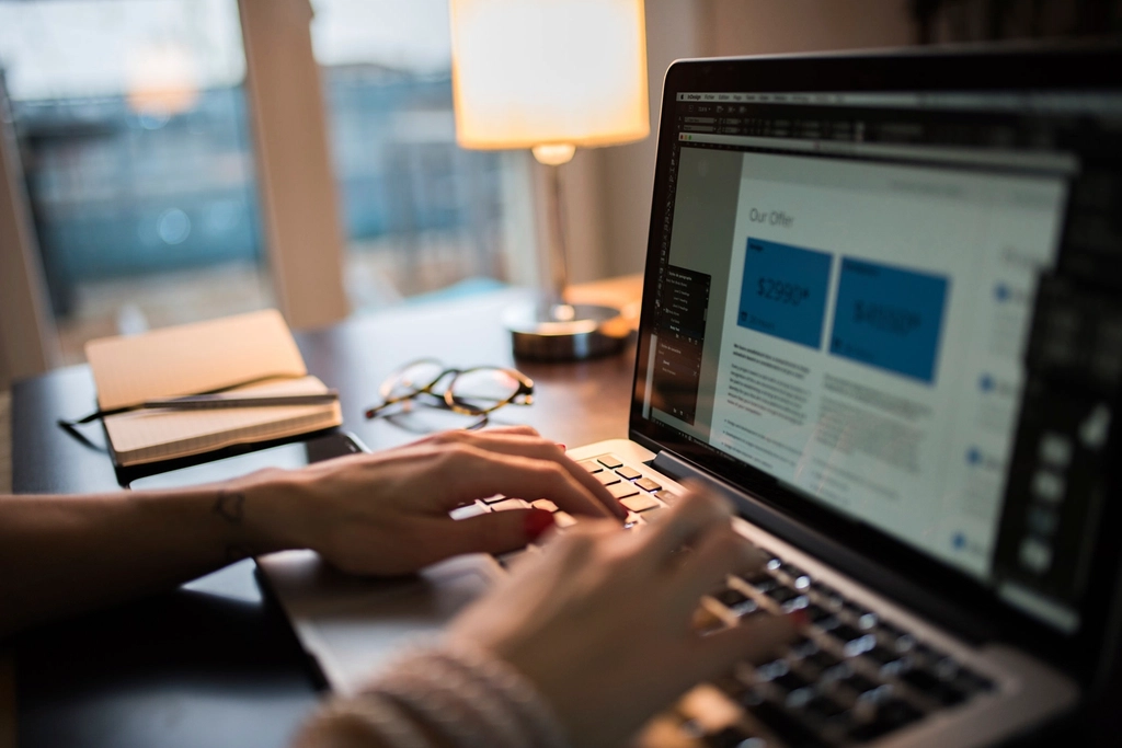 Designer reviewing graphic design pricing and package offers on a laptop screen