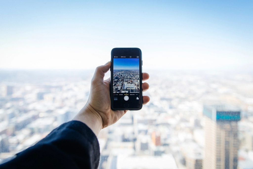Hand holding a smartphone, representing WhatsApp commerce for Dubai retailers